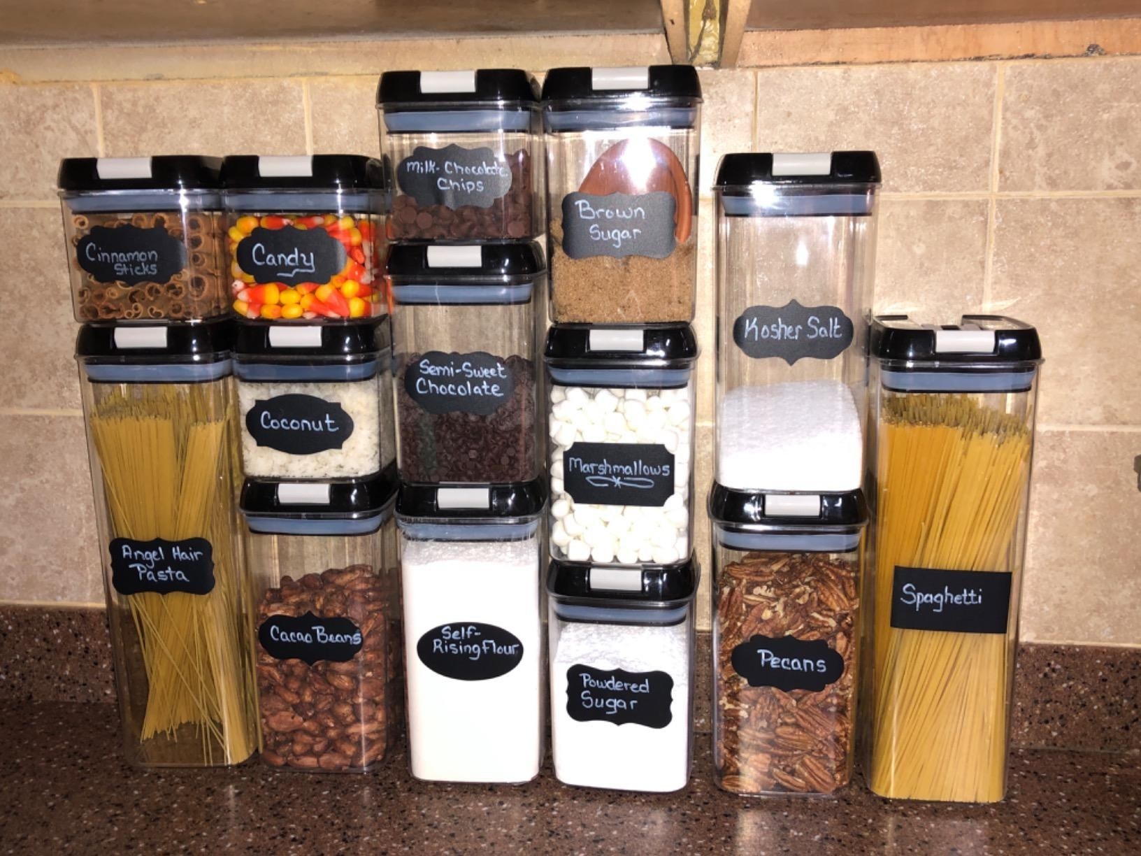 different sized clear containers with chalkboard labels holding dry goods