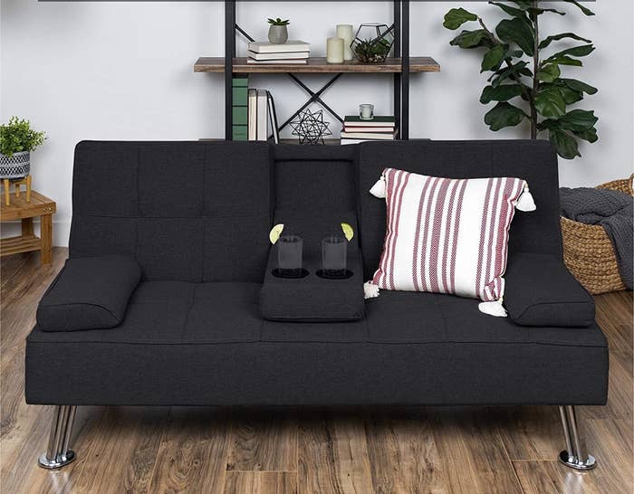 Black tufted sofa with pull out drink holder 