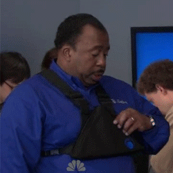 GIF of Stanley from The Office pulling out a slice of pizza from a pizza-shaped fanny pack