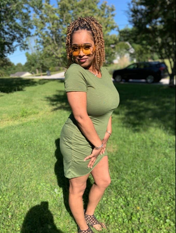 A reviewer wearing a green, casual, short sleeve, ruched, body-con t-shirt dress