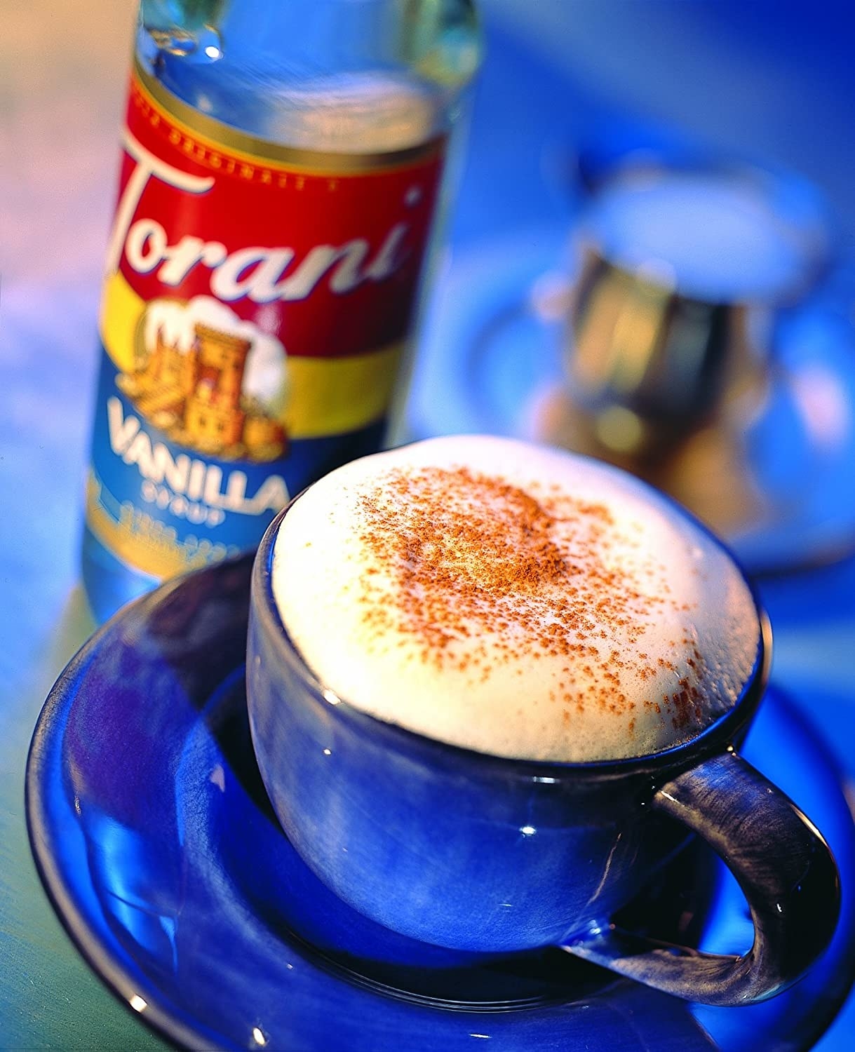 a coffee beverage next to the syrup bottle