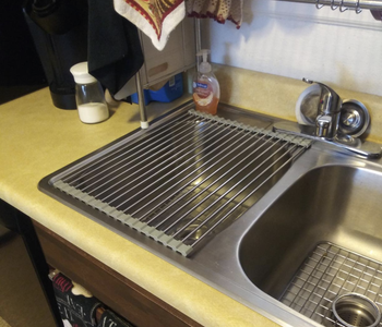 The drying rack rolled over a sink 