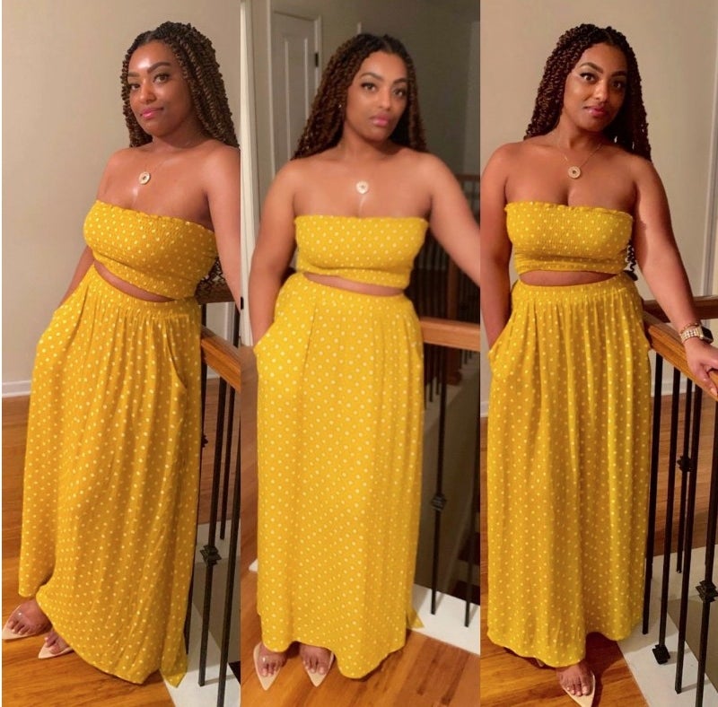 A reviewer wearing the yellow/white polka dot bandeau top and maxi skirt