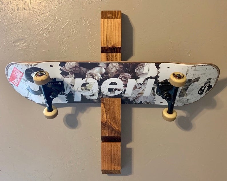 the wooden skateboard rack mounted on a wall
