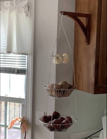 Hanging baskets holding potatoes 