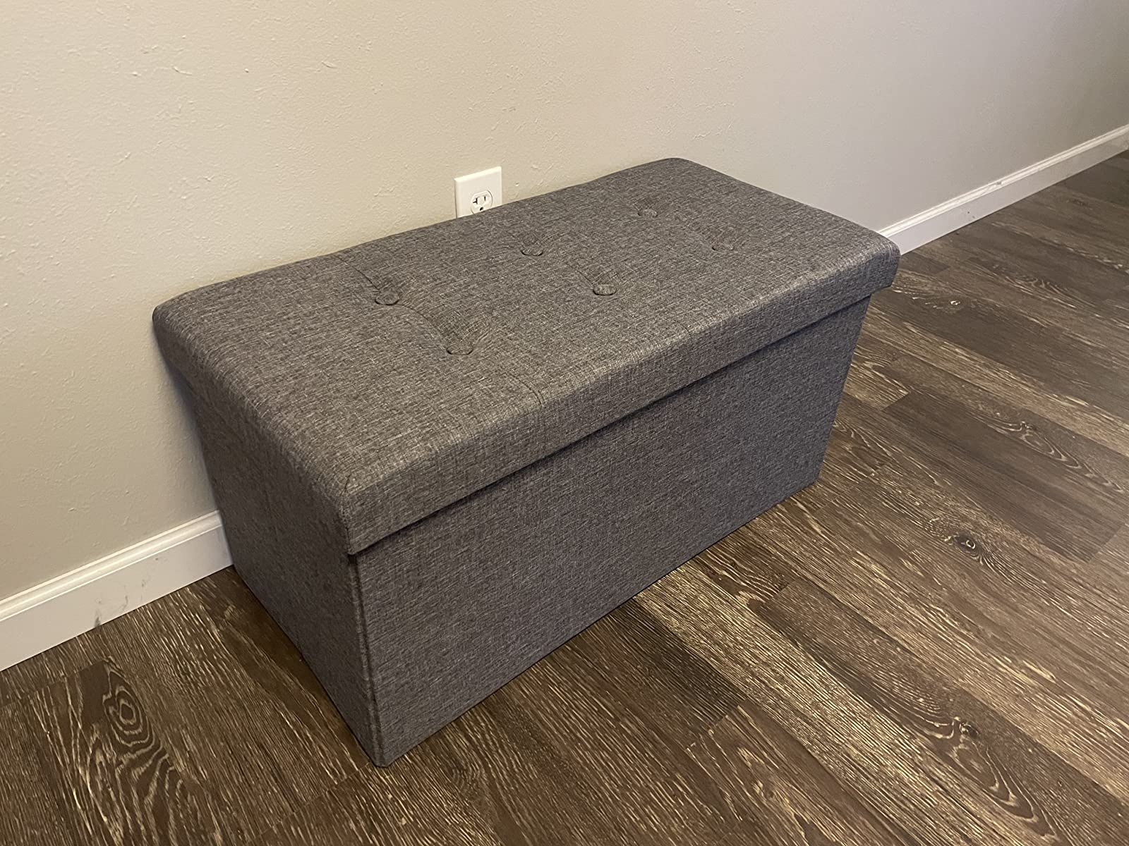 The rectangular tufted bench in an entryway