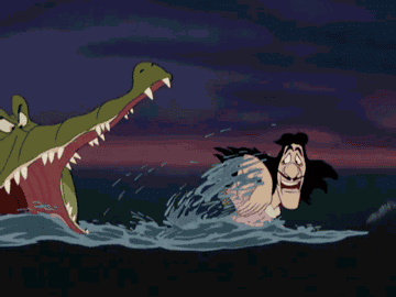 Captain Hook swimming away from a crocodile