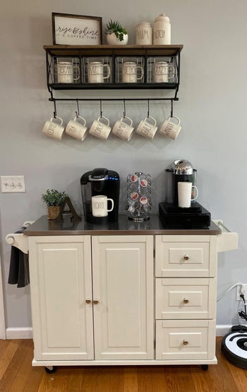 The kitchen cart being used as a coffee bar with three drawers and a cabinet