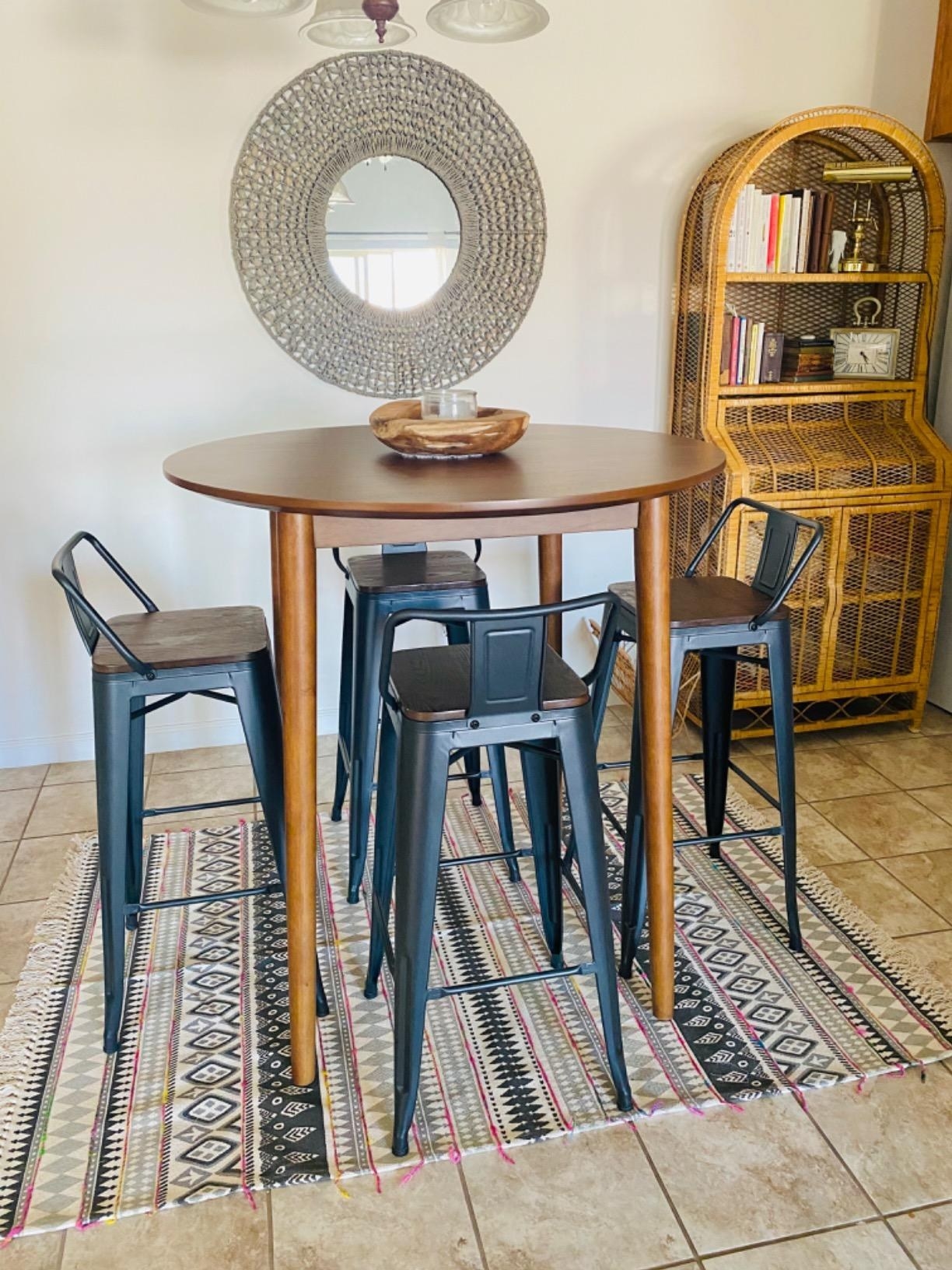 The bar stools with a metal frame and back around a circular table