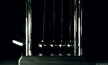 A Newton&#x27;s cradle clacking back and forth