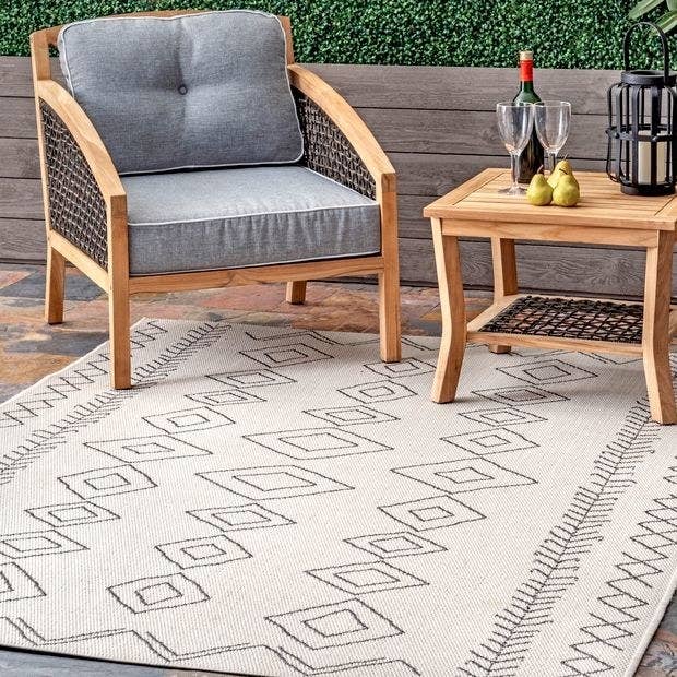 a white rug with a gray abstract design on it