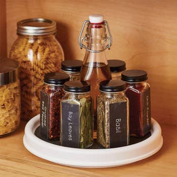 Same turn table with spices on it in a cabinet 