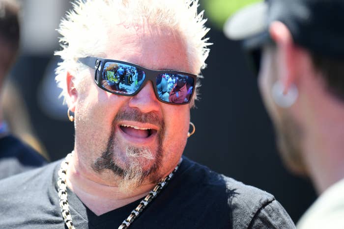 Guy Fieri laughs while wearing sunglasses