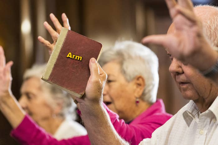 A man holding up a book with the caption &#x27;arm&#x27; written over it