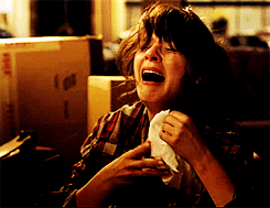 GIF of woman sobbing and holding a tissue