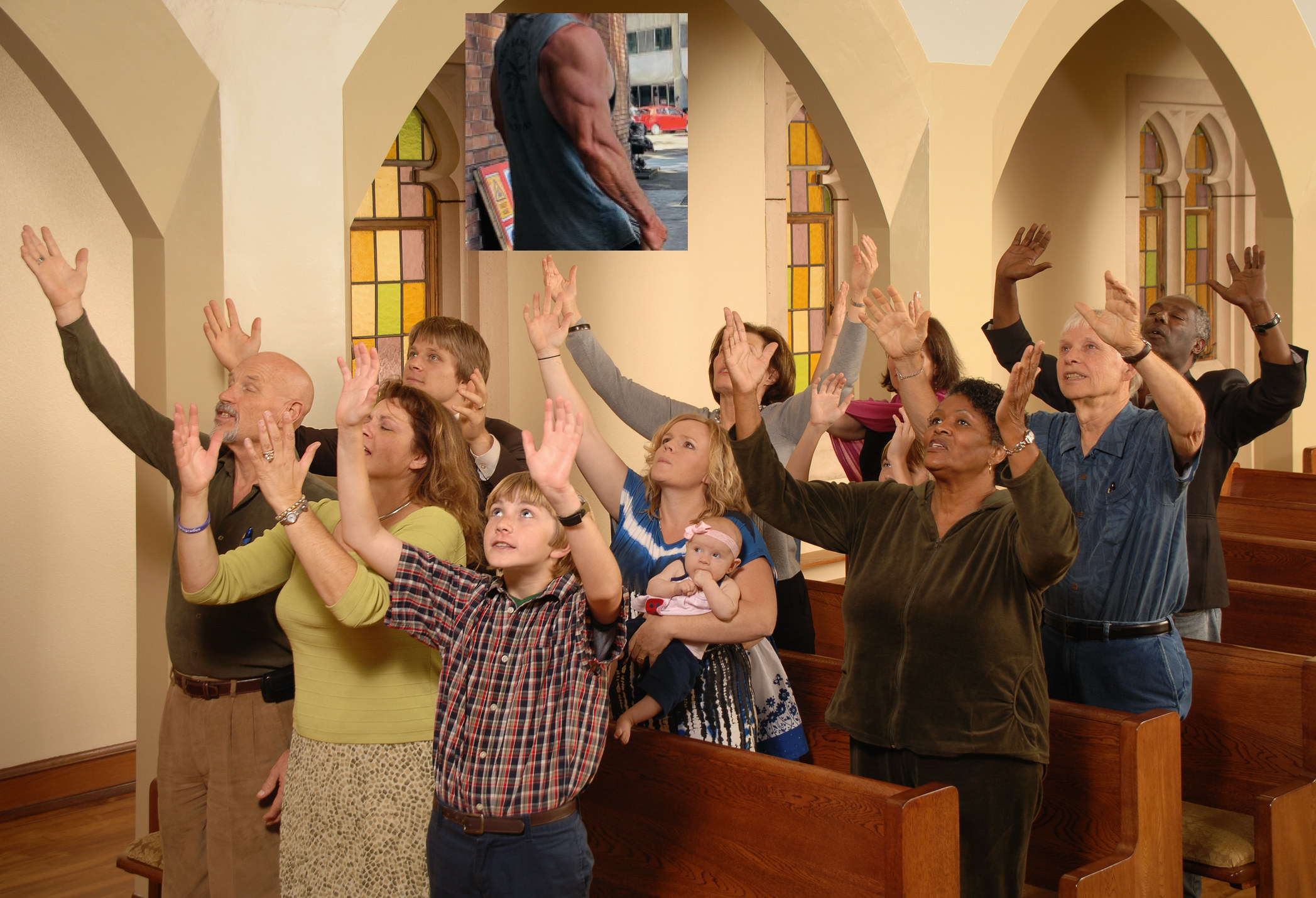 People in church with their arms raised to the sky