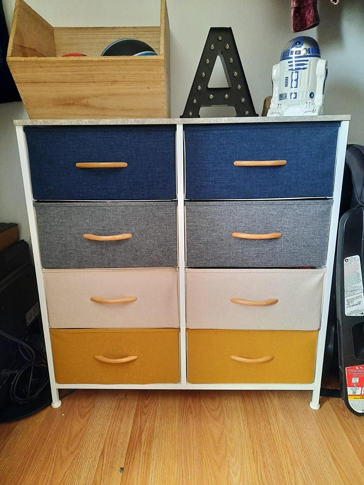 The dresser with eight drawers of different colors with wooden handles