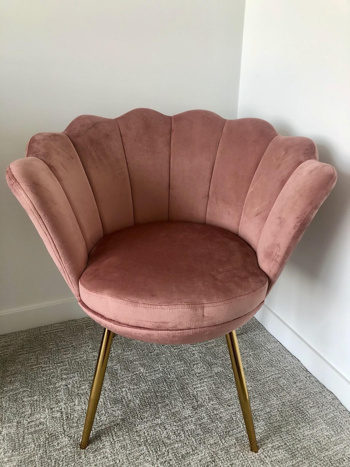 The petal chair in antique pink with a flower-shaped back and four gold legs