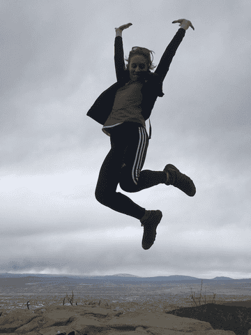 A GIF of the author jumping in the air on a hike 
