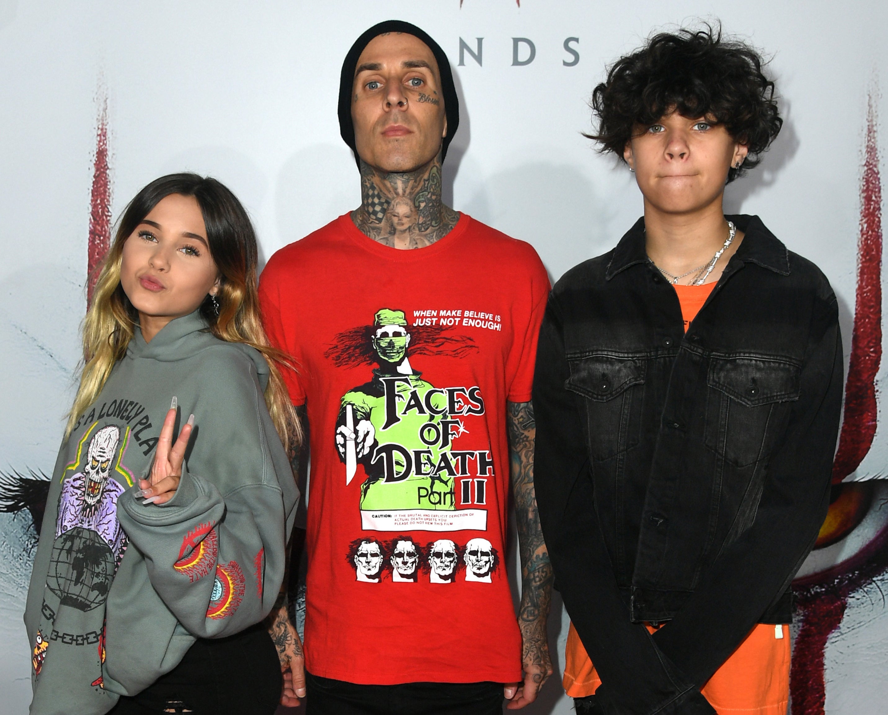 Travis poses with his two children