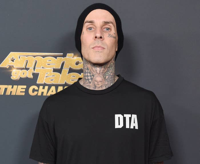 Travis looks serious while attending an event