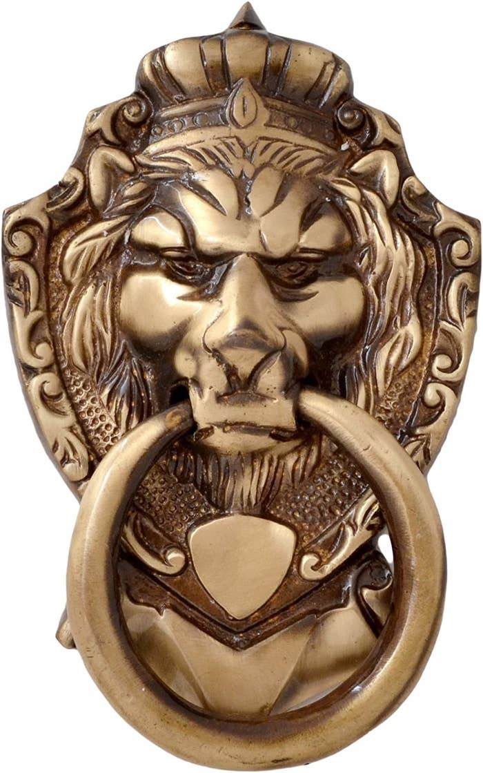 A brass Victorian-style door knocker shaped like a lion.