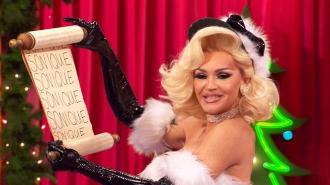 Kylie holding a scroll that says &quot;Sonique&quot;