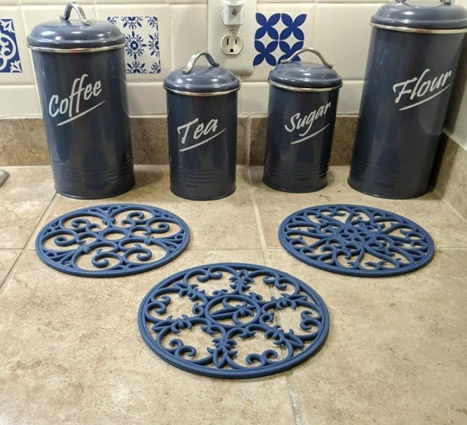 The trivets in dark blue on a reviewer&#x27;s countertop 