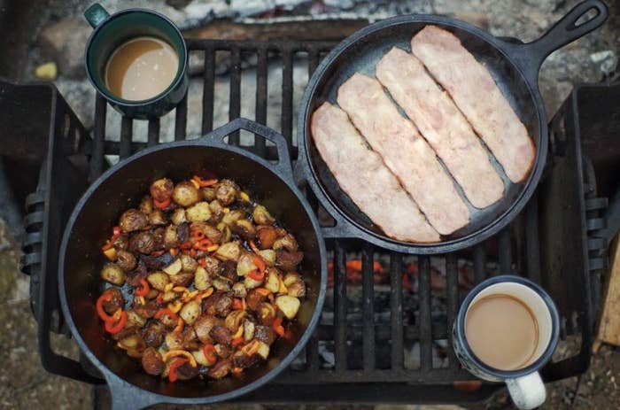 both cast iron skillets in use during a camping trip