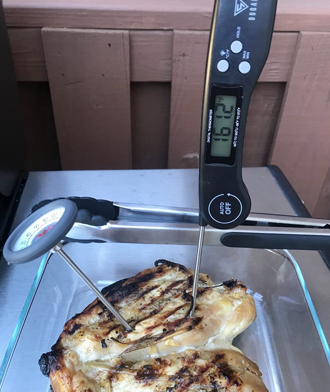 a digital food thermometer measuring the temperature of a piece of meat