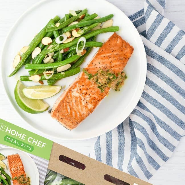salmon and green beans on a plate with a home chef meal kit box next to it
