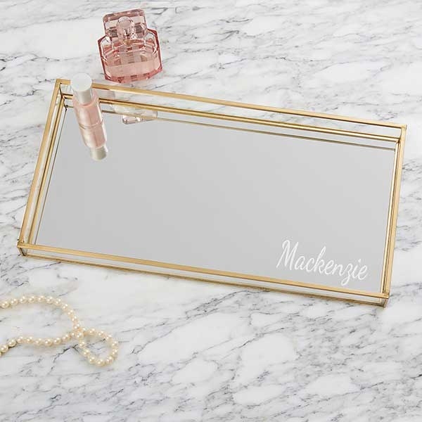 a gold tray with a mirrored base