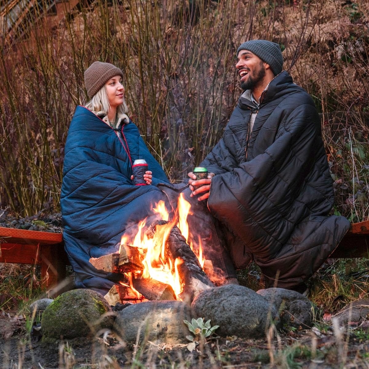 two models outside camping with rumpl blankets draped around them