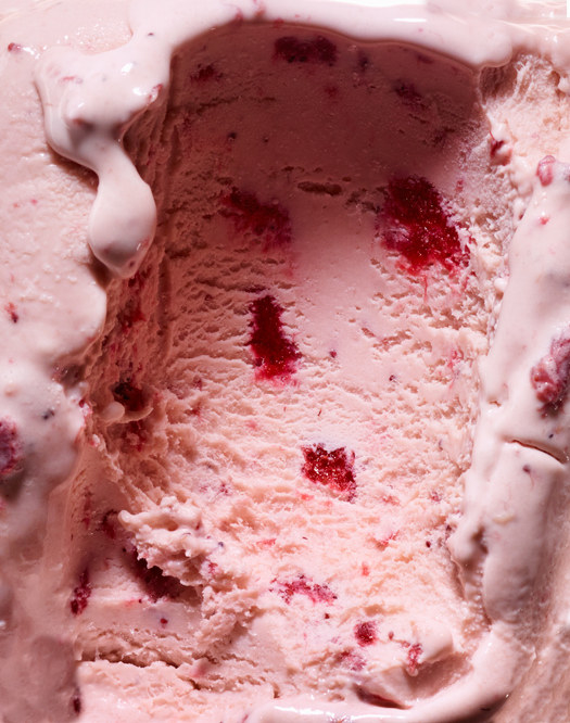 A scooped out portion of strawberry ice cream.