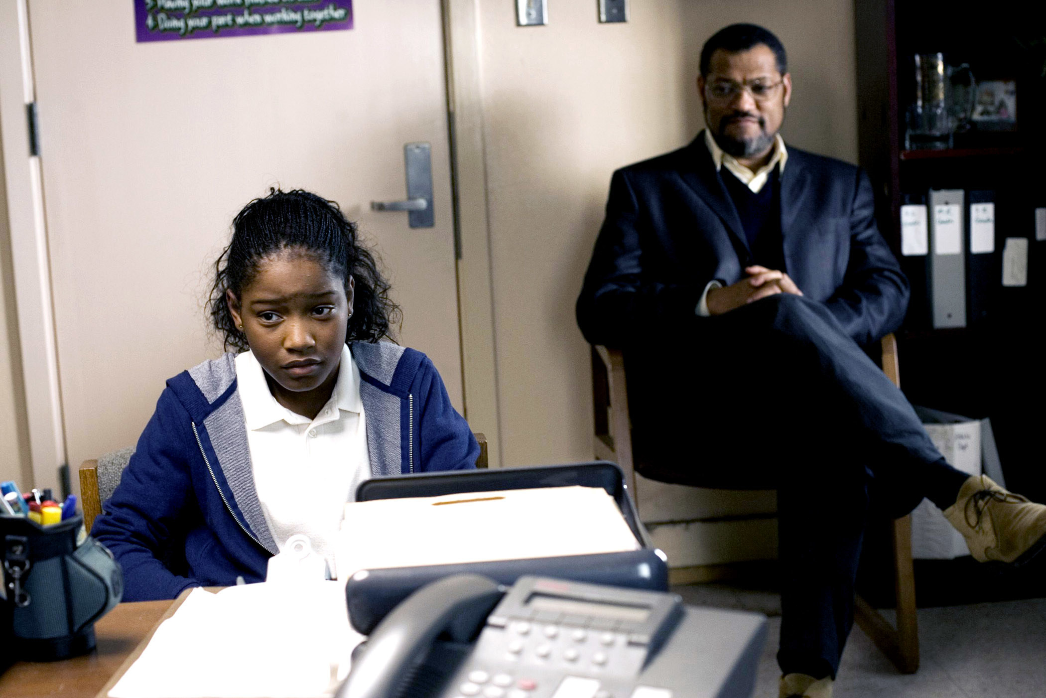 Keke Palmer and Laurence Fishburne sit in an office