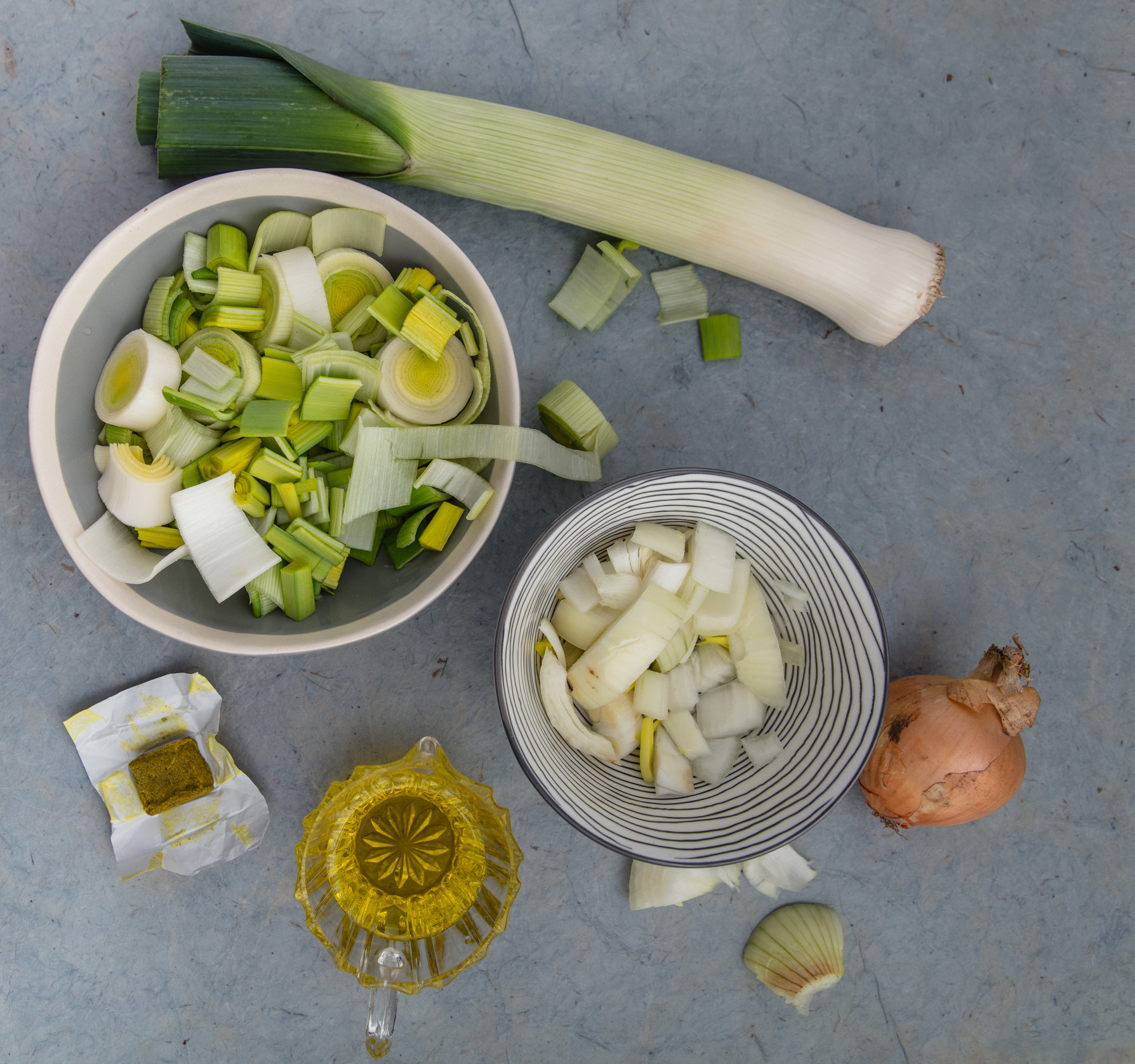 Leeks, onions, a bouillon cube, and olive oil