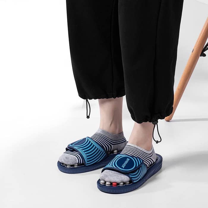 A person wearing the reflexology slippers