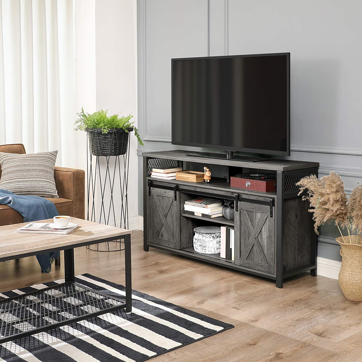 the TV unit with books and decor in it