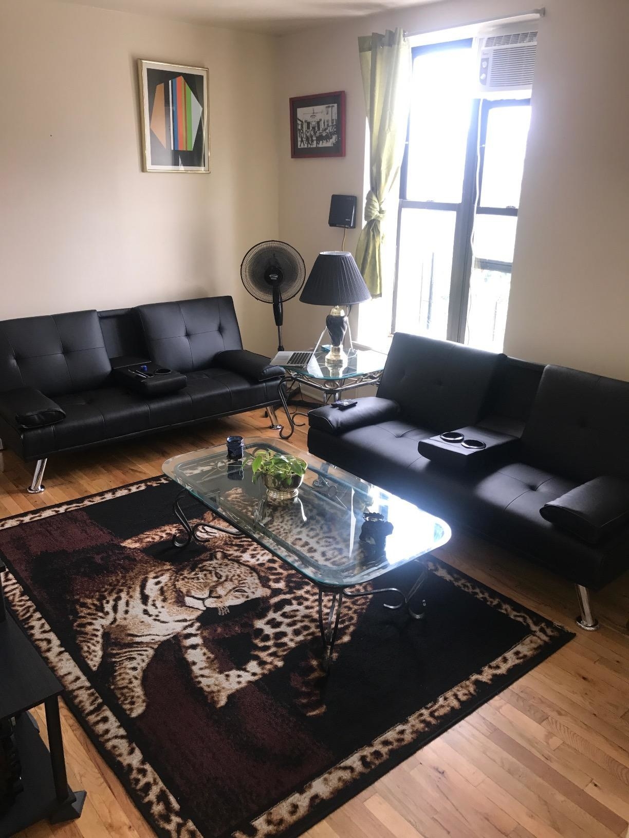 Two of the futons in a living room with this really rad tiger rug in between them. ~Rawr!~