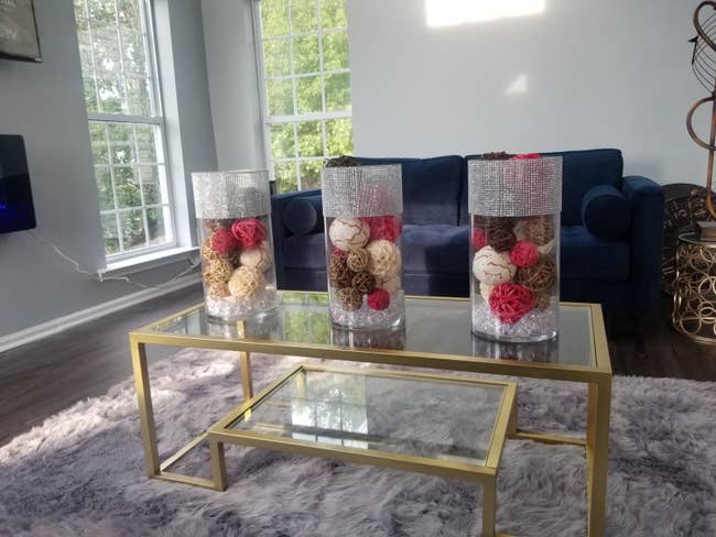 The glass and gold coffee table in a living room