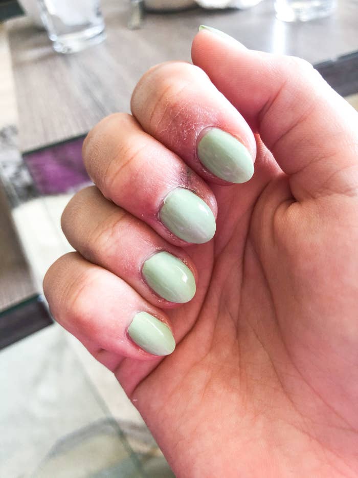 A close up of someone&#x27;s nails painted with the minty green nail polish