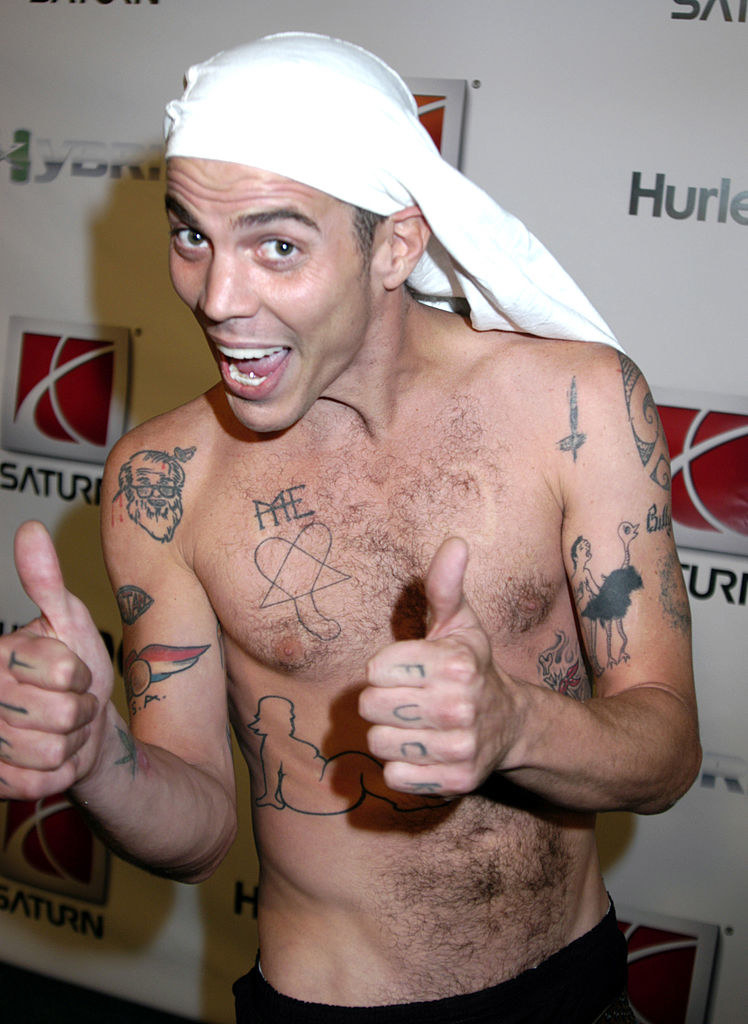A shirtless Steve-O giving the thumbs up