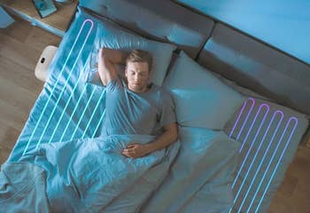 A man in bed with the ChiliPAD sleep system