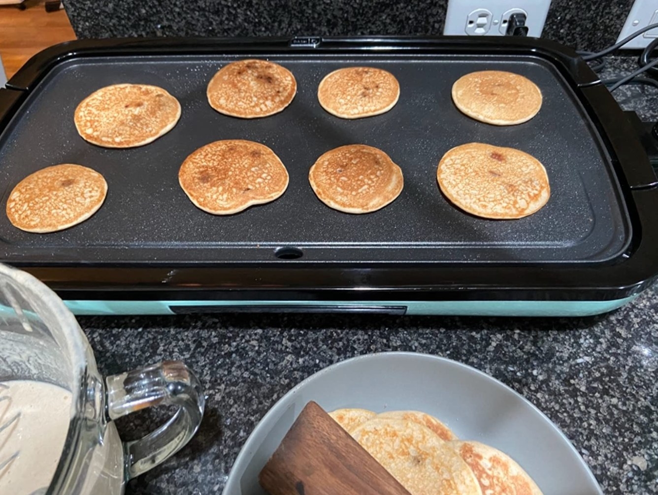 Eight pancakes on a griddle