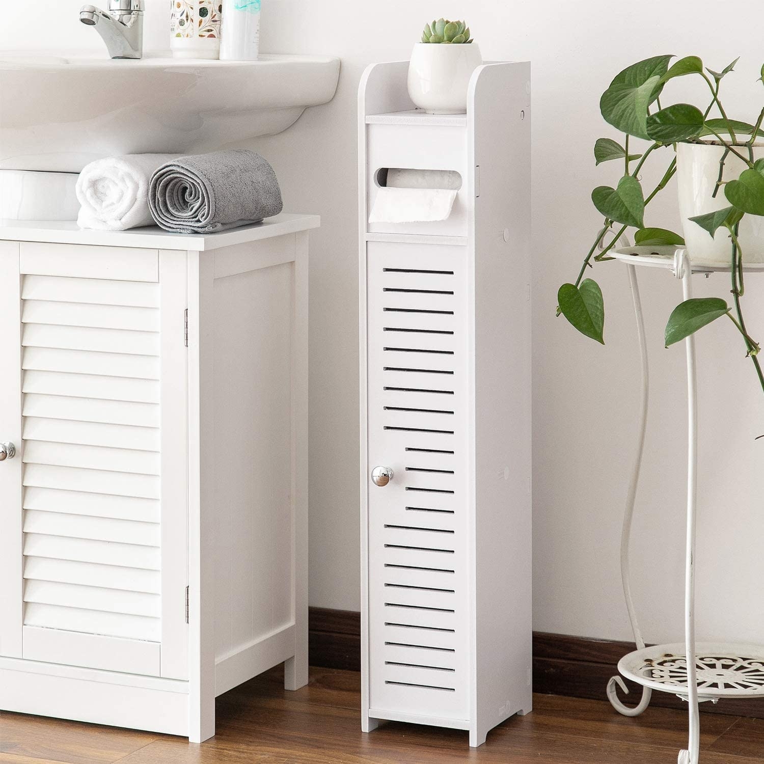 A small scrolled storage cabinet that fits in tight bathroom corner