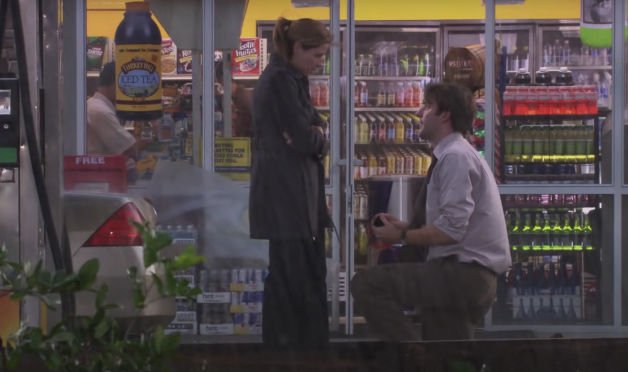 Jim gets down on one knee outside the gas station