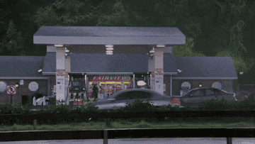 Cars rush by the fake gas station