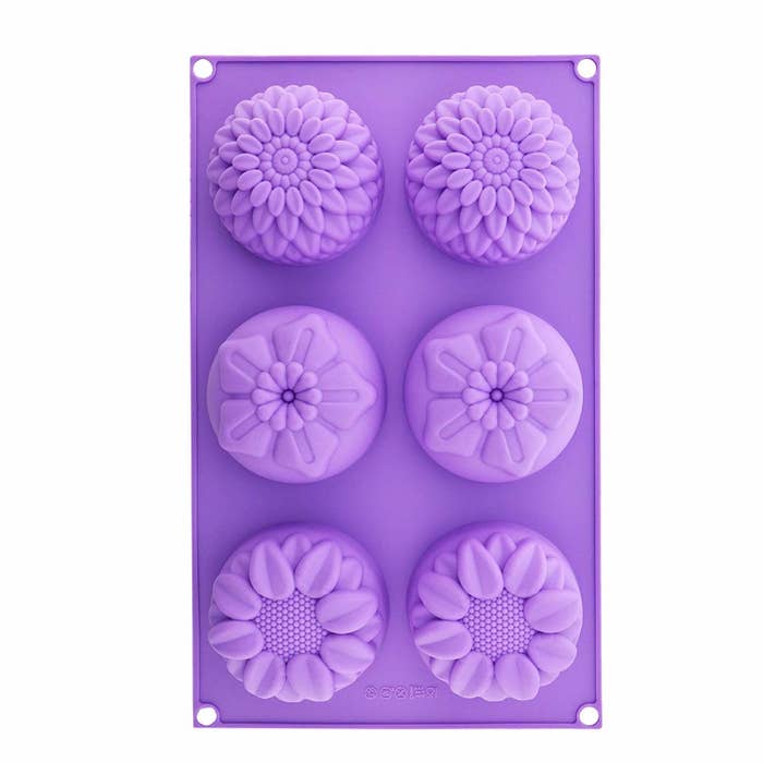 Purple silicone mould with three flower shapes including sunflowers and chrysanthemums