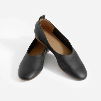 pair of black leather flats stacked on top of each other
