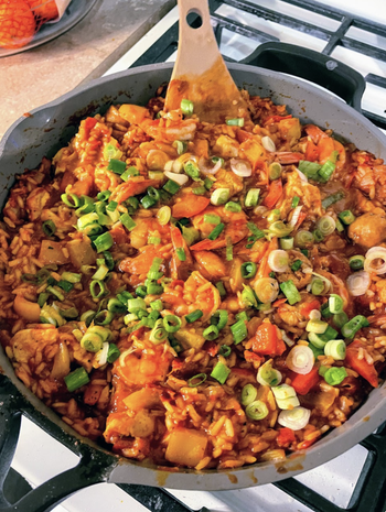 A pan full of a rice and veggie dish 